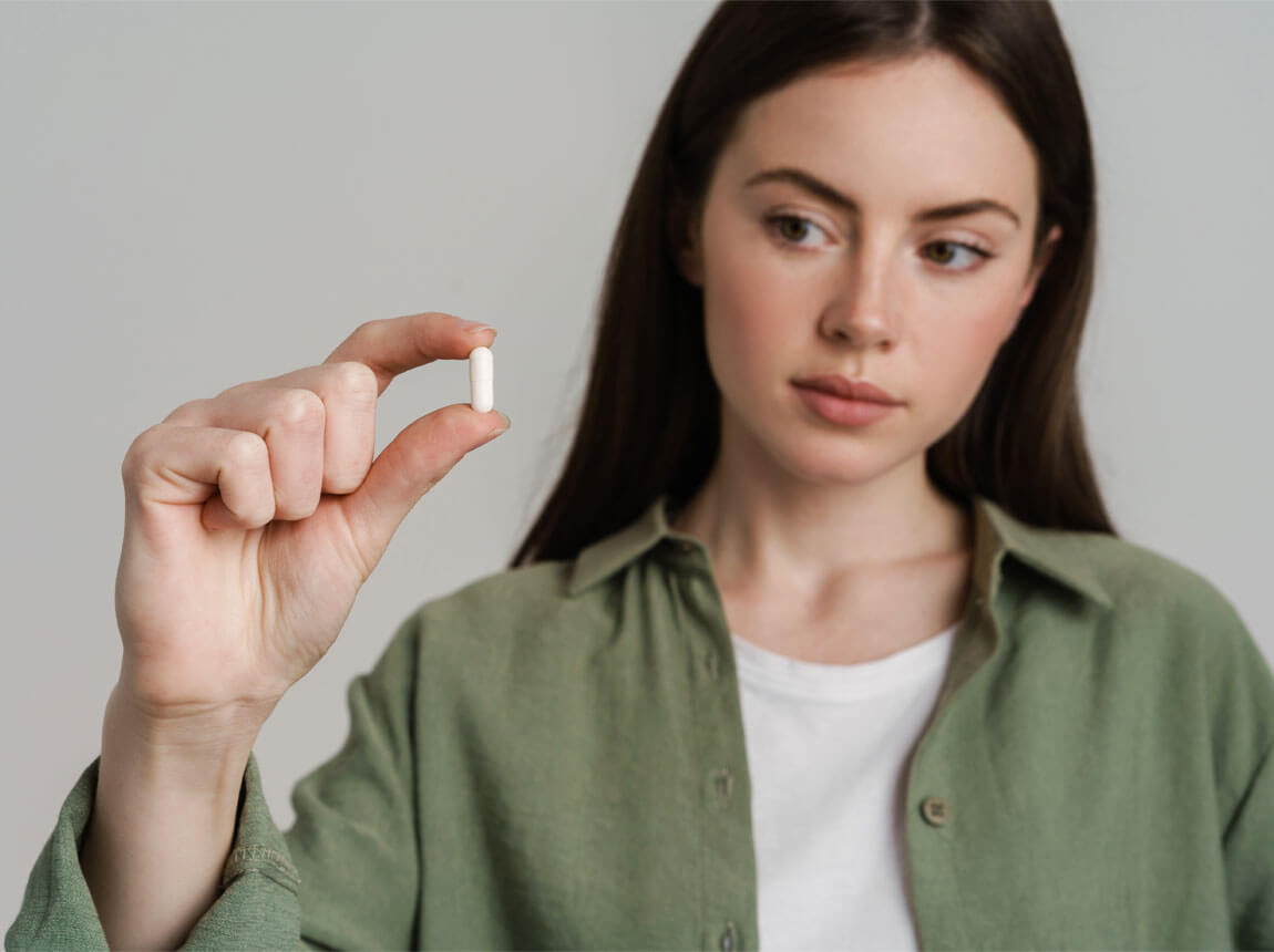 žena s kapsulou - zinok